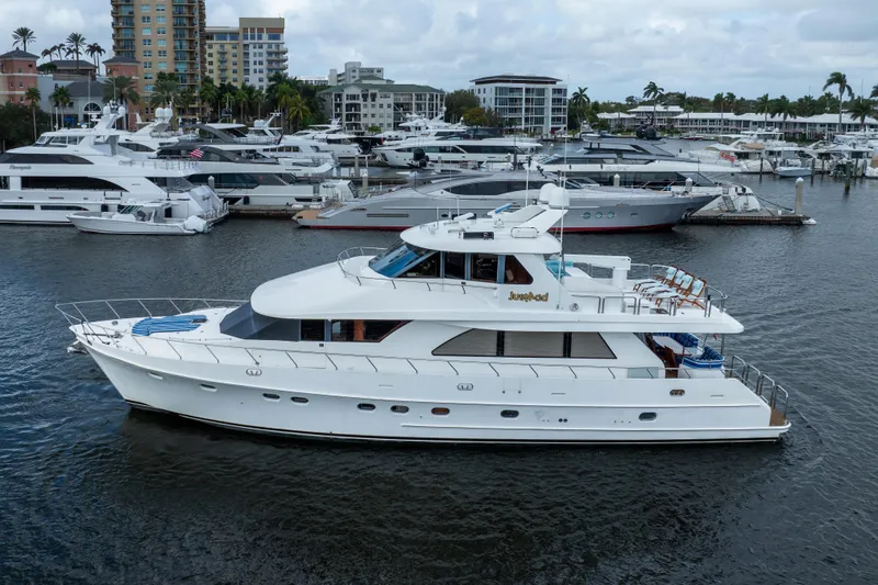 Slide: The Image of 2005 Ocean Alexander 80 Motoryacht docked in a marina with other luxury boats. - 96