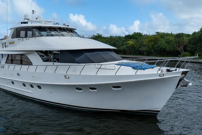 Slide: The Image of 2005 Ocean Alexander 80 Motoryacht cruising on a serene waterway. - 98