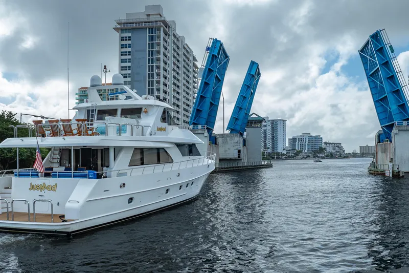 Slide: The Image of 2005 Ocean Alexander 80 Motoryacht passing under raised drawbridge in urban waterway. - 99
