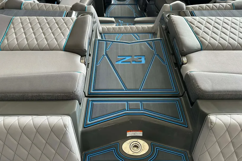 Slide: The Image of 2026 Tigé Z3 boat interior with quilted gray seats and blue accents. - 15