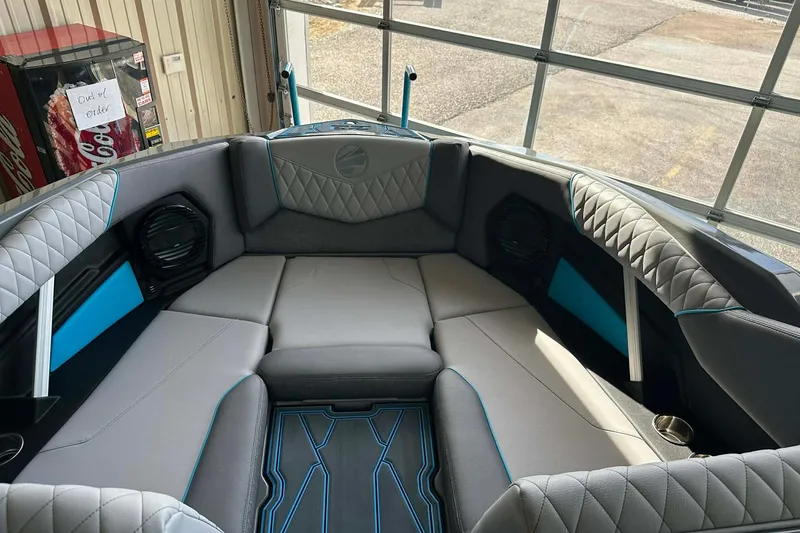 Slide: The Image of 2026 Tigé Z3 boat interior with gray and blue seating, diamond stitching, and cup holders. - 17