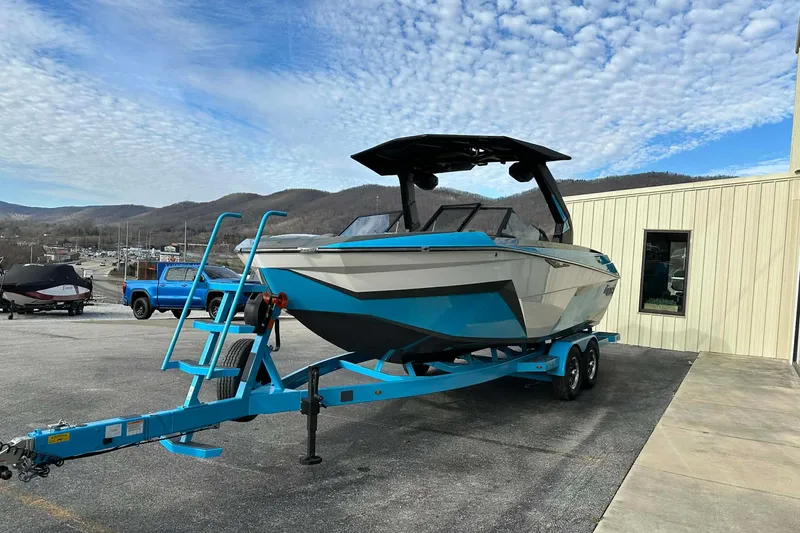 Slide: The Image of 2026 Tigé Z3 boat on trailer, parked outdoors with scenic mountain backdrop. - 3