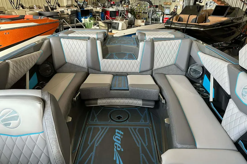 Slide: The Image of 2026 Tigé Z3 boat interior with luxurious seating and modern design in a showroom. - 8