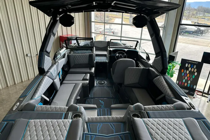 Slide: The Image of 2026 Tigé Z3 boat interior with luxurious seating and modern design in a showroom. - 9