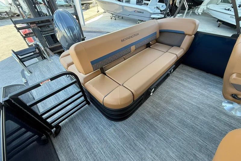 Slide: The Image of 2026 Bennington 22 M Swingback boat interior with tan seating and modern design. - 10