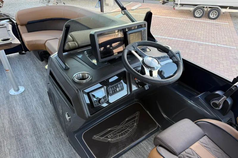 Slide: The Image of 2026 Bennington 22 M Swingback boat interior with modern dashboard and steering wheel. - 12