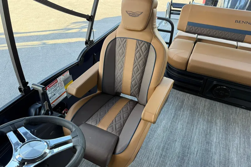 Slide: The Image of 2026 Bennington 22 M Swingback boat interior with luxurious seating and steering wheel. - 15