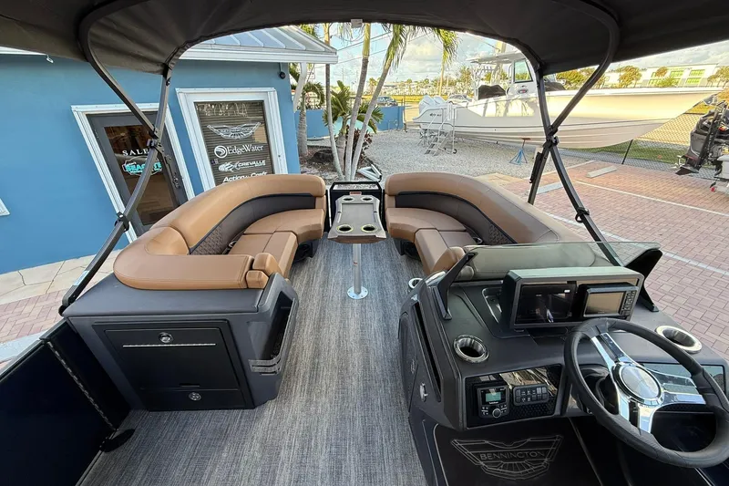 Slide: The Image of 2026 Bennington 22 M Swingback pontoon boat interior with luxurious seating and modern dashboard. - 16