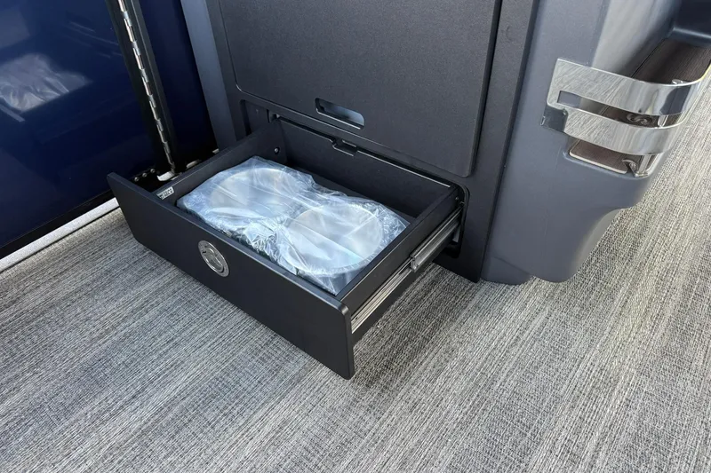 Slide: The Image of 2026 Bennington 22 M Swingback boat with open storage drawer on deck. - 19