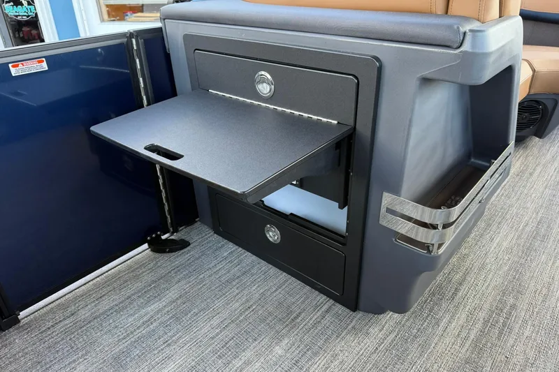 Slide: The Image of 2026 Bennington 22 M Swingback interior with pull-out table and storage compartments. - 20