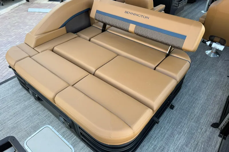 Slide: The Image of 2026 Bennington 22 M Swingback boat with tan cushioned seating and sleek design. - 8