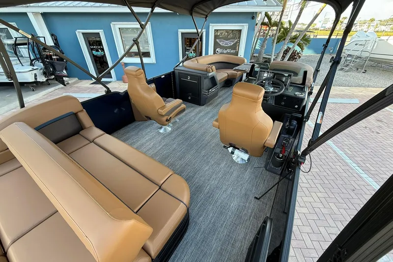 Slide: The Image of 2026 Bennington 22 M Swingback boat interior with tan seating and modern dashboard. - 9