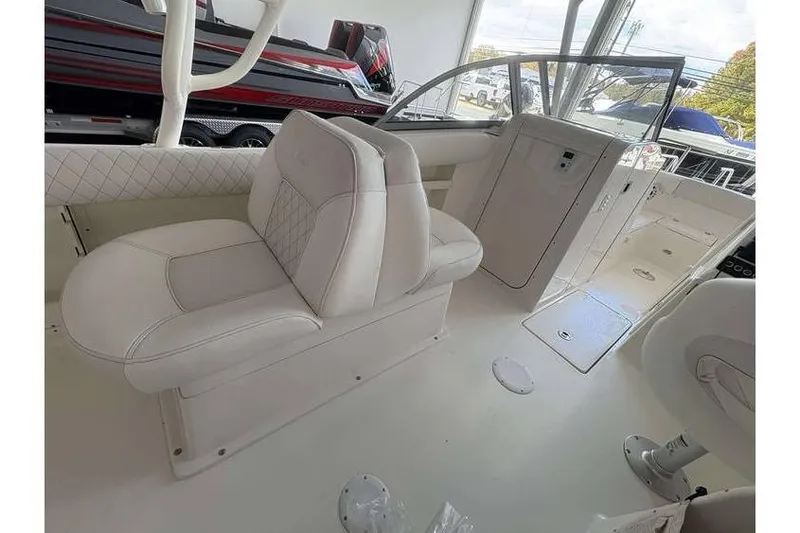 Slide: The Image of 2026 Key West 239 DFS boat interior with white seating and modern design. - 10