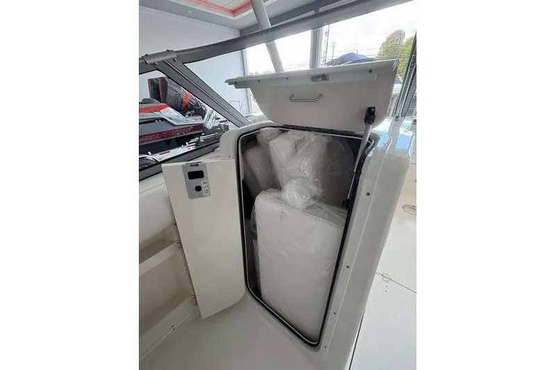 Slide: The Image of 2026 Key West 239 DFS boat storage compartment with cushions inside. - 11
