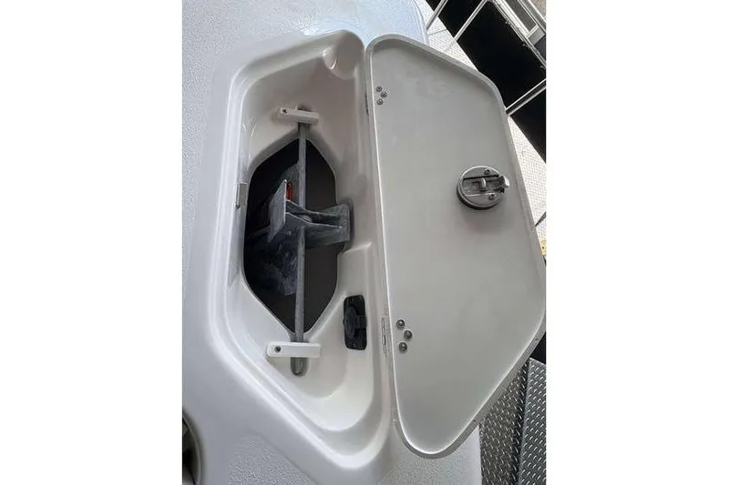 Slide: The Image of Open anchor compartment on 2026 Key West 239 DFS boat, showcasing storage design. - 18