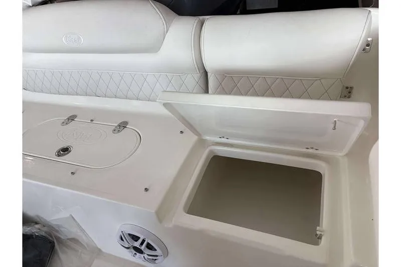 Slide: The Image of 2026 Key West 239 DFS boat interior with open storage compartment and cushioned seating. - 19