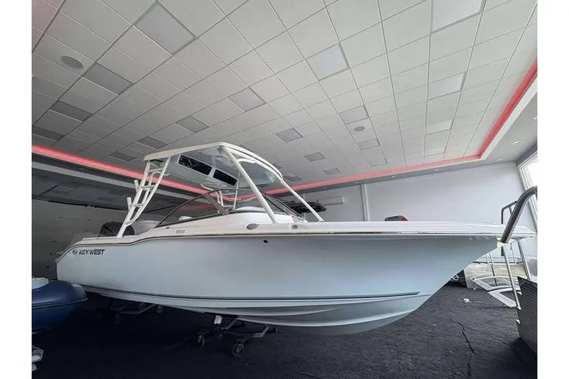 Slide: The Image of 2026 Key West 239 DFS boat displayed indoors with modern design and sleek structure. - 2