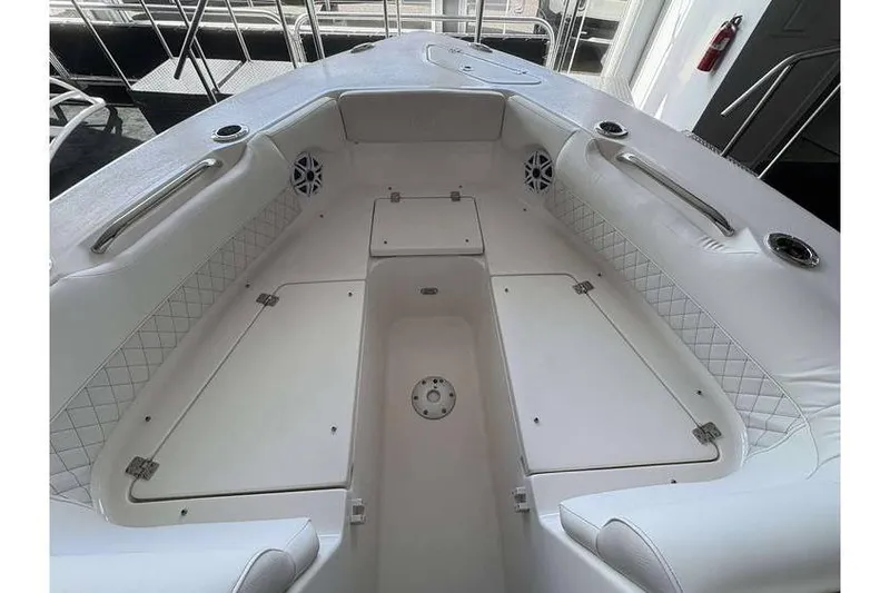 Slide: The Image of 2026 Key West 239 DFS boat interior with white seating and storage compartments. - 21