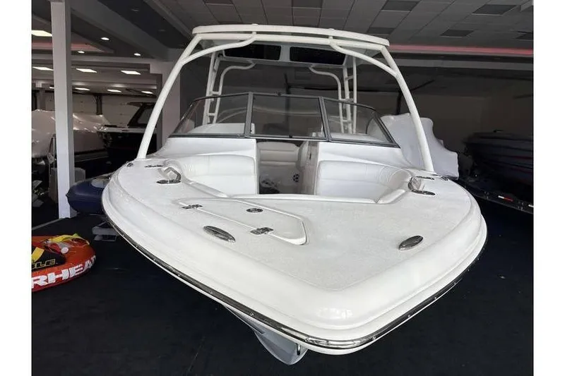 Slide: The Image of 2026 Key West 239 DFS boat with sleek white design in showroom. - 4