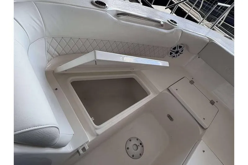 Slide: The Image of 2026 Key West 239 DFS boat interior with open storage compartment and speaker. - 8