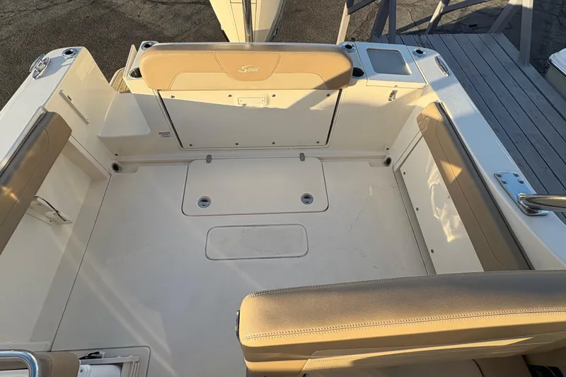 Slide: The Image of 2024 Scout 240 Dorado boat interior with beige seating and storage compartments. - 12