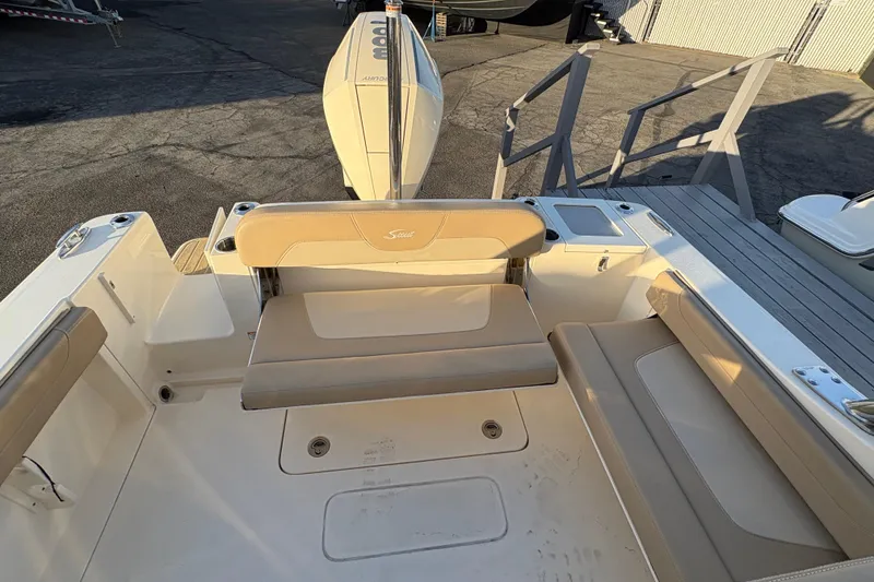 Slide: The Image of 2024 Scout 240 Dorado boat interior with beige seating and deck view. - 13