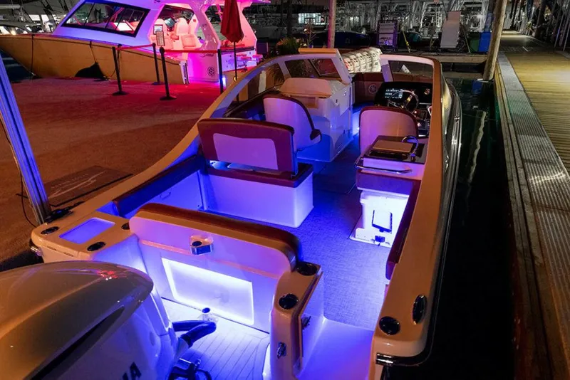 Slide: The Image of 2024 Scout 240 Dorado boat with Mercury outboard engine, docked on wooden deck. - 3