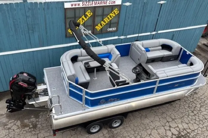 Slide: The Image of 2026 Sun Tracker Party Barge 20 DLX pontoon boat with trailer, displayed at Sizzle Marine. - 5