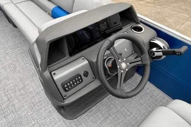 Slide: The Image of 2026 Sun Tracker Party Barge 20 DLX steering console with modern controls and seating. - 8