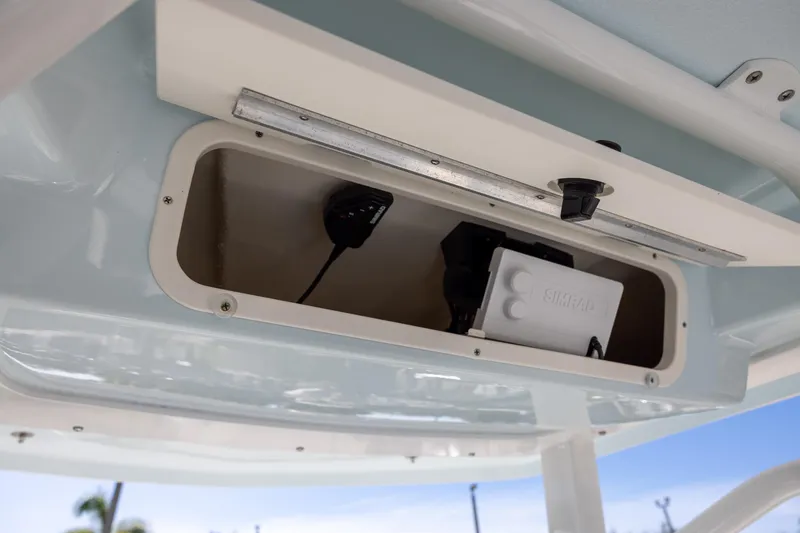 Slide: The Image of 2024 Robalo 246 Cayman boat storage compartment with Simrad electronics. - 13