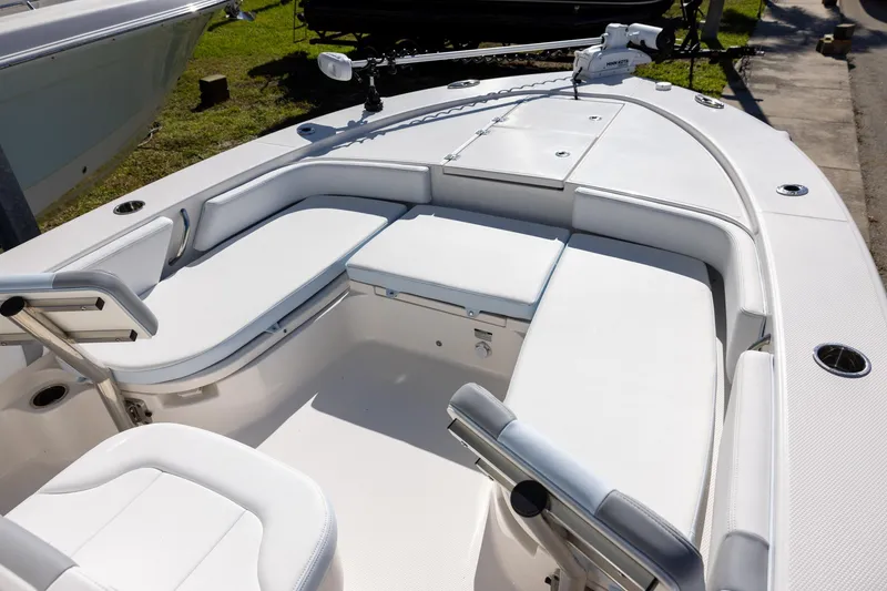 Slide: The Image of 2024 Robalo 246 Cayman boat interior with white seating and fishing rod holders. - 16