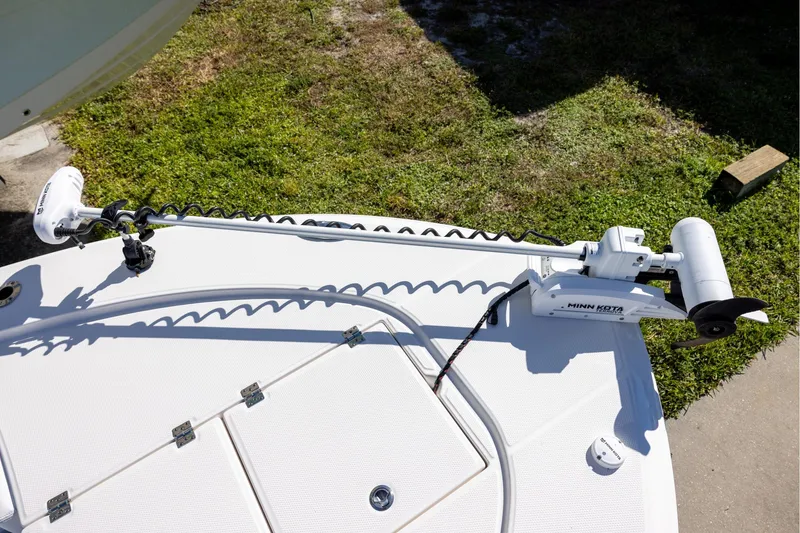 Slide: The Image of 2024 Robalo 246 Cayman boat with Minn Kota trolling motor on deck. - 18