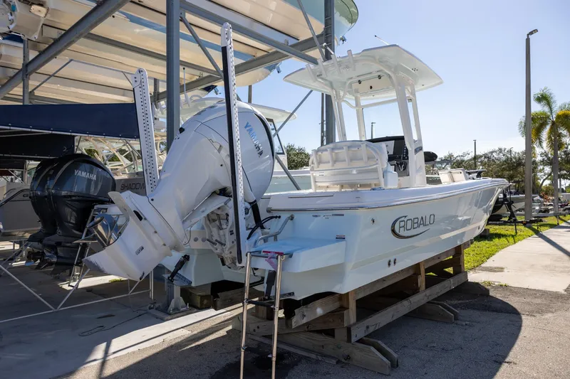 Slide: The Image of 2024 Robalo 246 Cayman boat with Yamaha engine on display at a marina. - 3