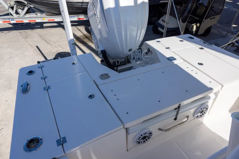 Slide: The Image of 2024 Robalo 246 Cayman boat deck with Yamaha outboard motor, featuring storage compartments. - 6