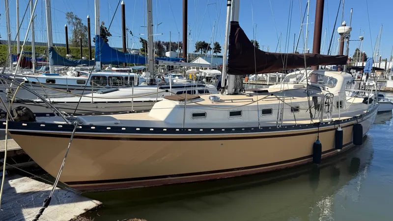 The Image of 1984 Cascade 36 sailboat docked in marina, featuring beige hull and black trim. - 0