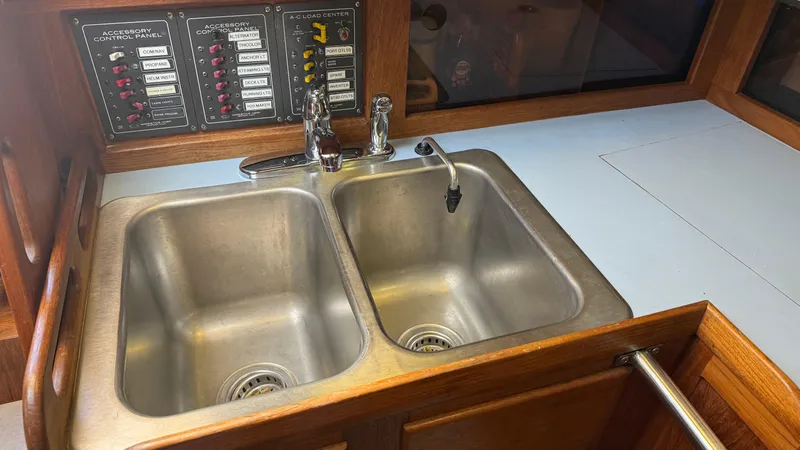 Slide: The Image of Double stainless steel sink in a 1984 Cascade 36 boat galley with control panels. - 14