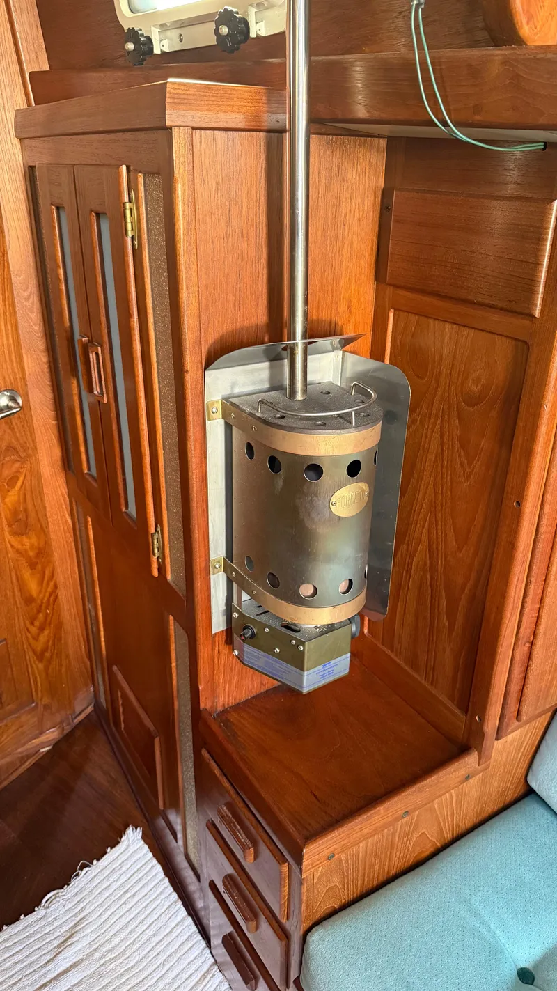 Slide: The Image of Wood-paneled interior with a vintage Cascade 36 heater, 1984 model, mounted on a wooden cabinet. - 16