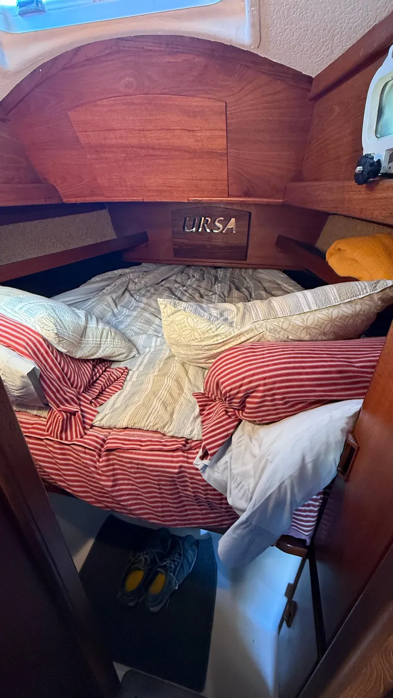 Slide: The Image of Cozy cabin interior of 1984 Cascade 36 sailboat with striped bedding and wooden accents. - 18