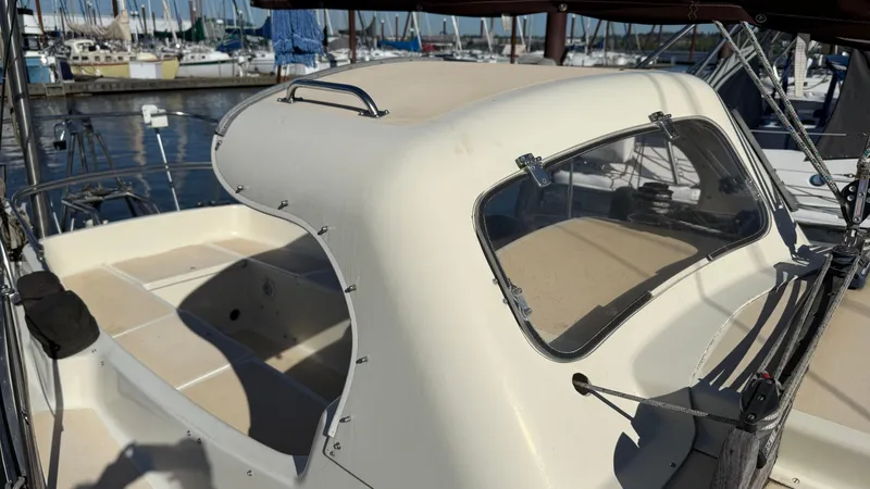 Slide: The Image of 1984 Cascade 36 sailboat cockpit with beige cover, docked at marina. - 21