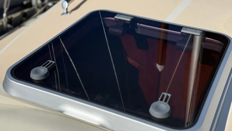 Slide: The Image of Hatch window on 1984 Cascade 36 sailboat, reflecting mast and rigging. - 26