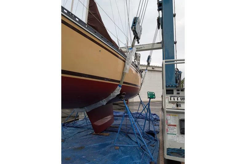 Slide: The Image of 1984 Cascade 36 sailboat on a lift, undergoing maintenance in a boatyard. - 30