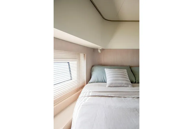 Slide: The Image of Manufacturer Provided Image: Luxurious bedroom interior of 2025 Azimut Seadeck 6 yacht with window view. - 8