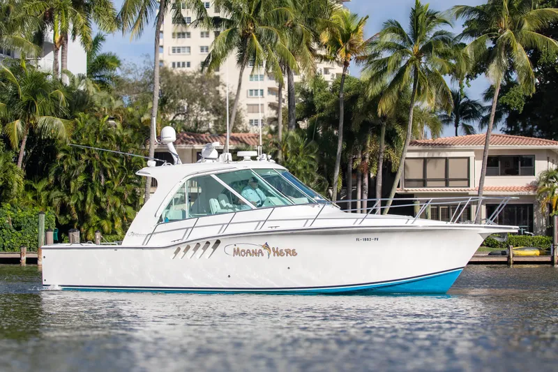 The Image of 2015 Albemarle 360 Express Fisherman boat on water, surrounded by palm trees and buildings. - 0