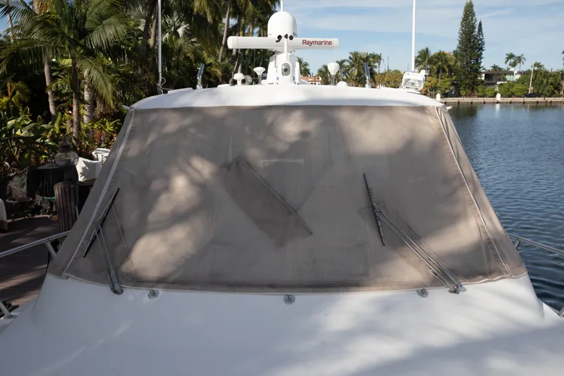 Slide: The Image of 2015 Albemarle 360 Express Fisherman boat with covered windshield, docked near tropical foliage. - 13