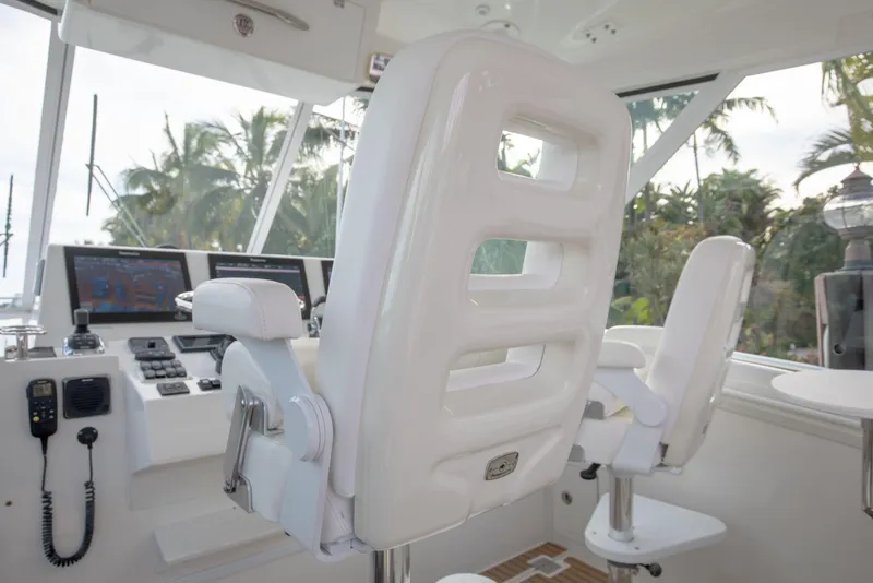 Slide: The Image of Helm of 2015 Albemarle 360 Express Fisherman with white captain's chairs and control panel. - 16
