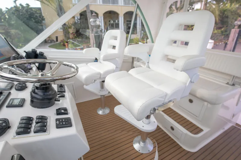 Slide: The Image of 2015 Albemarle 360 Express Fisherman helm with white captain chairs and control panel. - 18