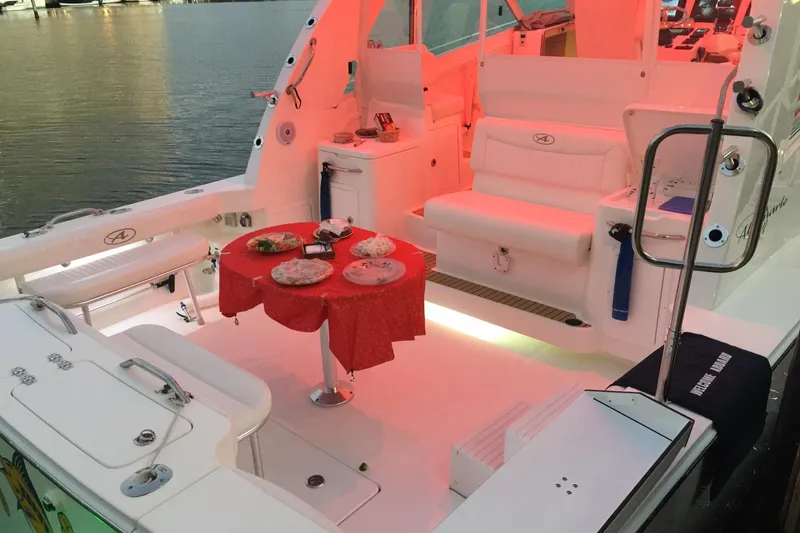 Slide: The Image of 2015 Albemarle 360 Express Fisherman boat interior with red lighting and dining setup. - 37