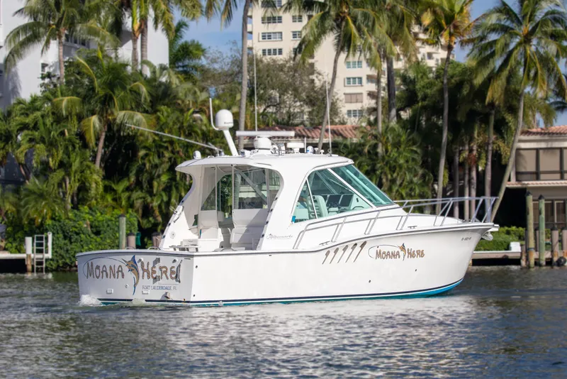 Slide: The Image of 2015 Albemarle 360 Express Fisherman boat cruising near palm trees and buildings. - 4