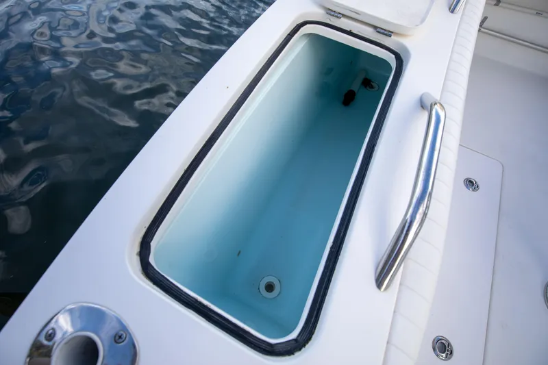 Slide: The Image of Open storage compartment on 2015 Albemarle 360 Express Fisherman boat, near water. - 42