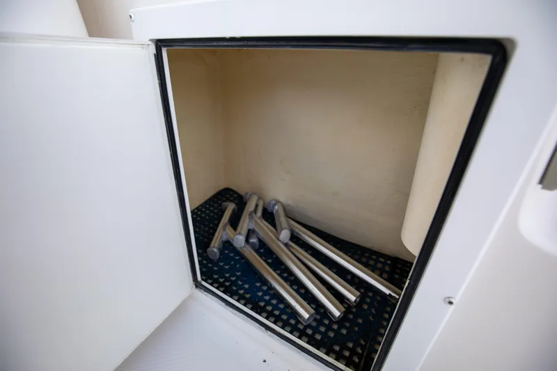 Slide: The Image of Storage compartment on 2015 Albemarle 360 Express Fisherman boat with metal rods inside. - 44